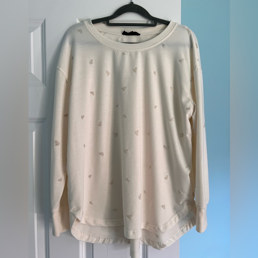 Cream colored top with embossed hearts